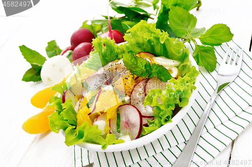 Image of Salad of radish and orange with mint on table