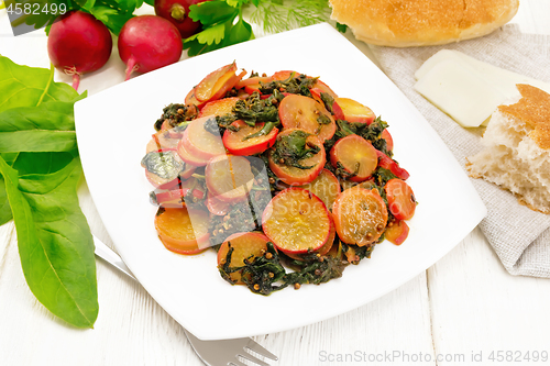 Image of Radish with spinach and spices in plate on white board