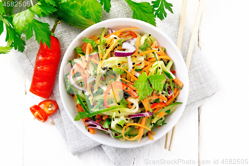 Image of Salad of cucumber in bowl on light board top