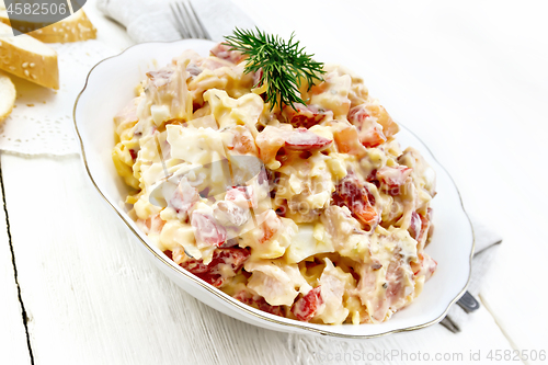 Image of Salad with chicken and vegetables in plate on light board