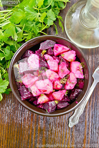 Image of Salad of beets and potatoes in bowl on board top