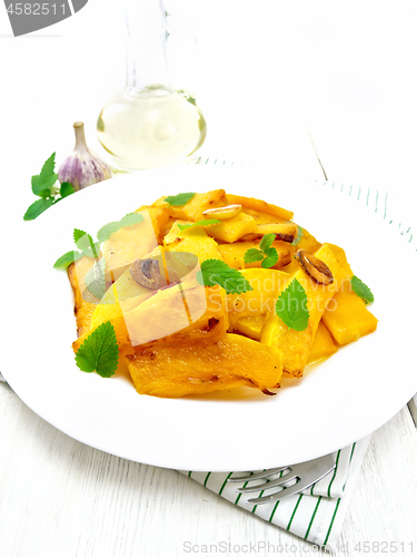 Image of Pumpkin with garlic and mint in plate on white board