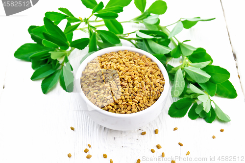 Image of Fenugreek with green leaves in bowl on board