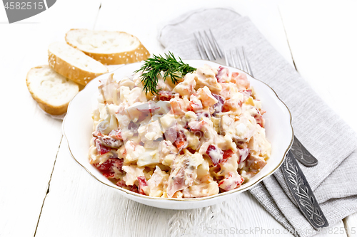 Image of Salad with chicken and vegetables in plate on table