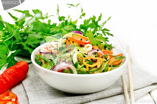 Image of Salad of cucumber in bowl on board