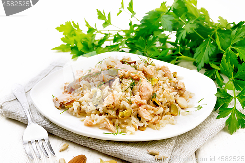 Image of Salad of salmon and rice in plate on board