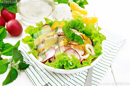 Image of Salad of radish and orange with mint on light board