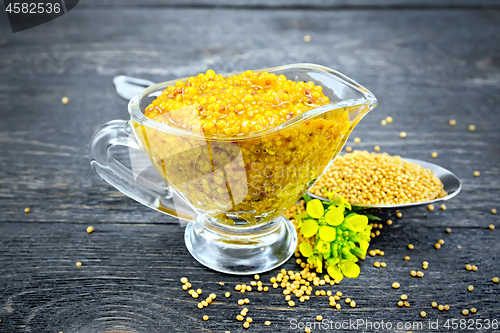 Image of Sauce mustard Dijon in sauceboat with flower on board