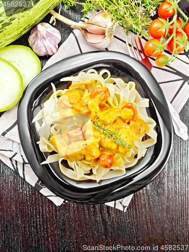 Image of Pasta with goulash in plate on dark board top