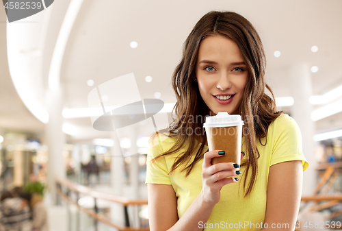 Image of teenage girl drinking coffee in shopping mall