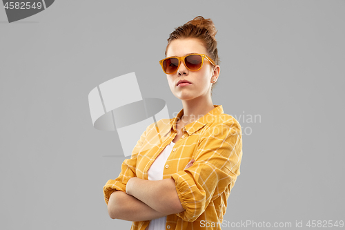 Image of red haired teenage girl in sunglasses