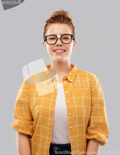 Image of smiling red haired teenage student girl in glasses