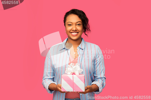 Image of happy african american woman with birthday present