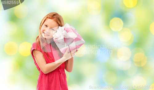 Image of lovely red haired girl with birthday gift