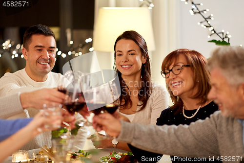 Image of happy family having dinner party at home