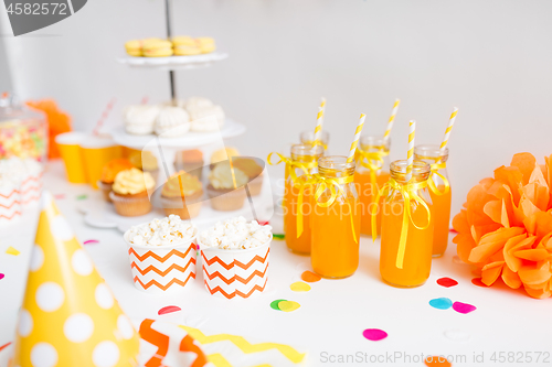 Image of lemonade or juice in glass bottles and popcorn