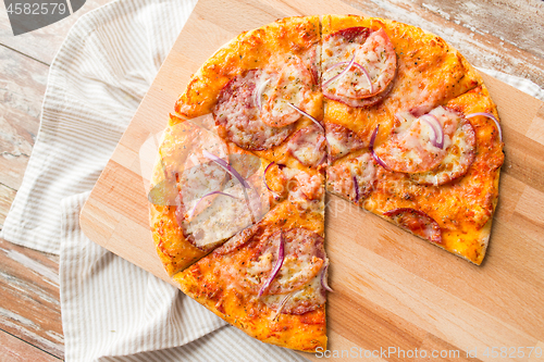 Image of close up of homemade pizza on wooden table