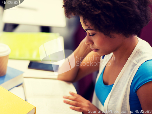 Image of student girl with books and coffee on lecture