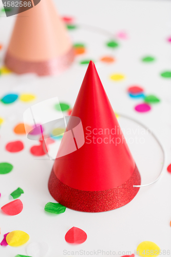 Image of red birthday party cap and confetti