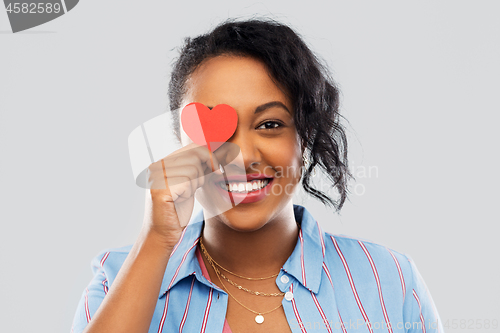 Image of happy african american woman with red heart