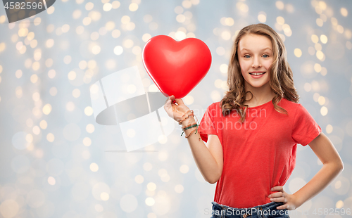 Image of smiling teenage girl with red heart shaped balloon