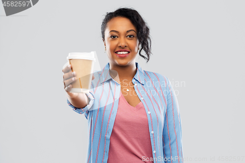 Image of happy african american woman drinking coffee