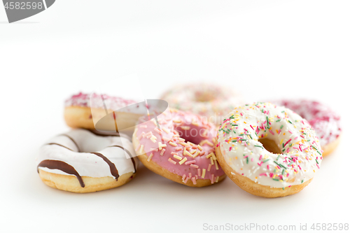 Image of close up of glazed donuts on white table