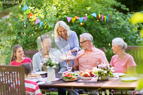 Image of happy family having dinner or summer garden party