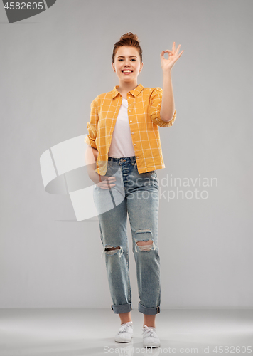 Image of happy red haired teenage girl showing ok hand sign