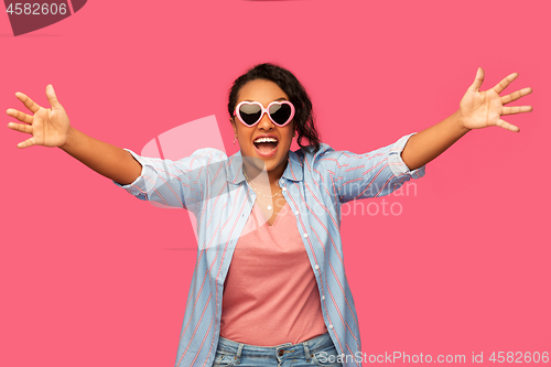 Image of african american woman in heart-shaped sunglasses