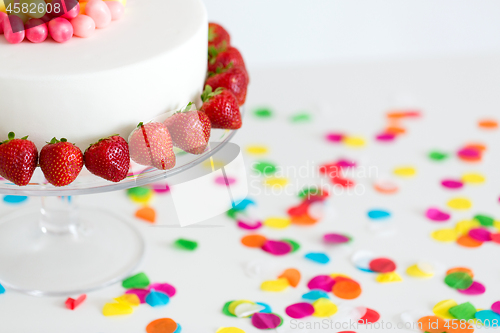 Image of close up of birthday cake with strawberries