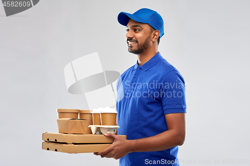 Image of happy indian delivery man with food and drinks