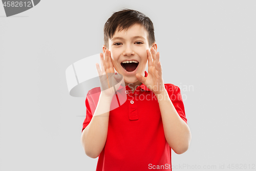 Image of boy in red polo t-shirt shouting or calling