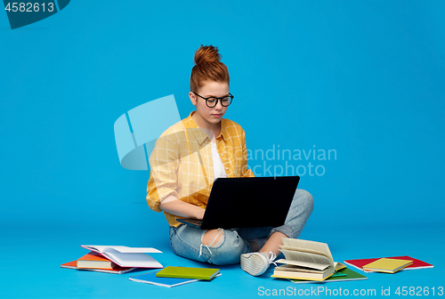 Image of redhead teenage student girl with laptop and books