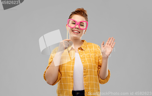 Image of smiling red haired teenage girl with big glasses