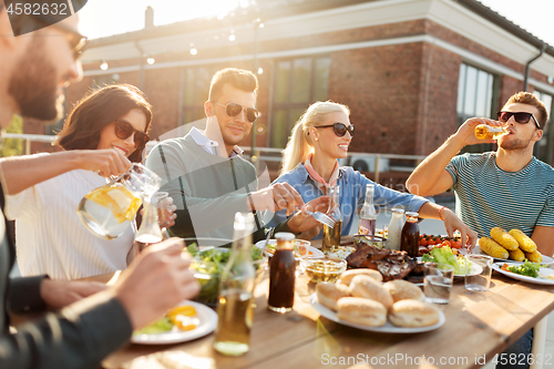 Image of friends having dinner or bbq party on rooftop