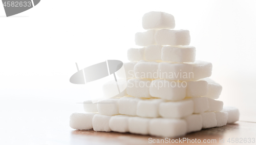 Image of close up of white lump sugar pyramid on table