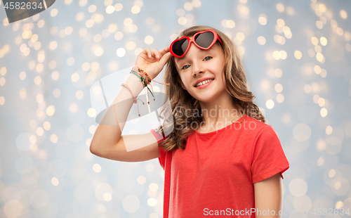 Image of happy teenage girl in red heart shaped sunglasses