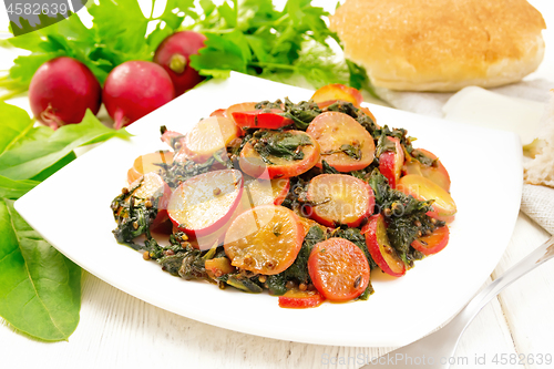 Image of Radish with spinach and spices in plate on table