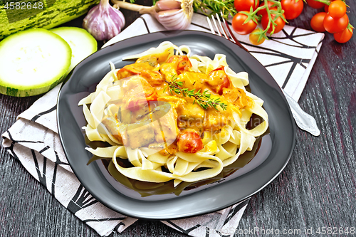 Image of Pasta with goulash in plate on dark board