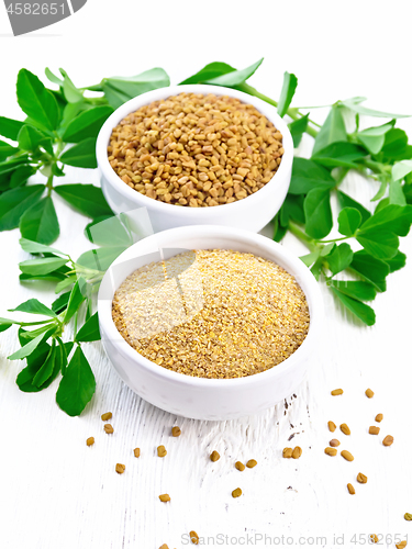 Image of Fenugreek in two bowls with leaves on board