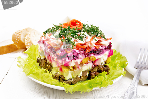 Image of Salad with beef and vegetables on light wooden table