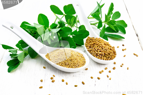 Image of Fenugreek in two spoons with leaves on white board
