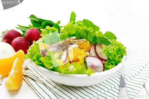 Image of Salad of radish and orange with mint on white board