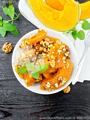 Image of Pumpkin with nuts and honey on wooden board top