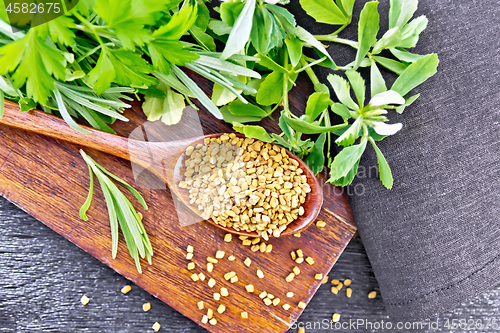 Image of Fenugreek in spoon with herbs on board top