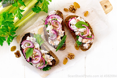 Image of Bruschetta with fish and curd on light board top