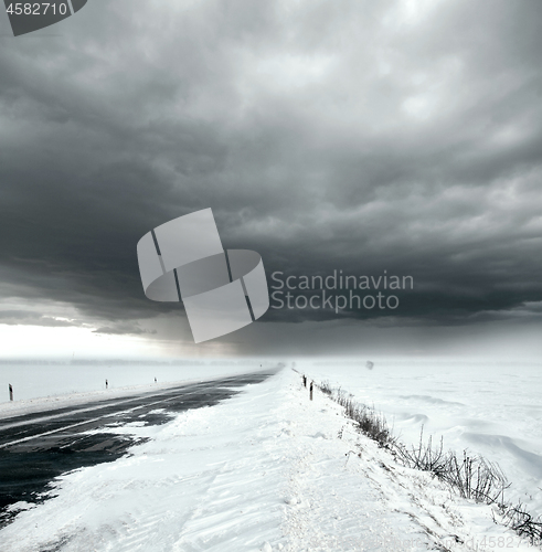 Image of Stormy sky and snow road