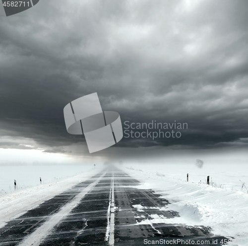 Image of Stormy sky and snow road