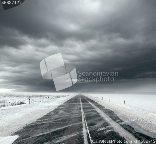 Image of Stormy sky and snow road